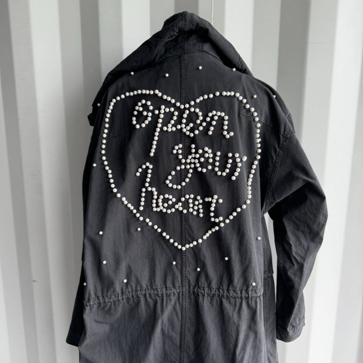 Trench style jacket with pearl beading on back