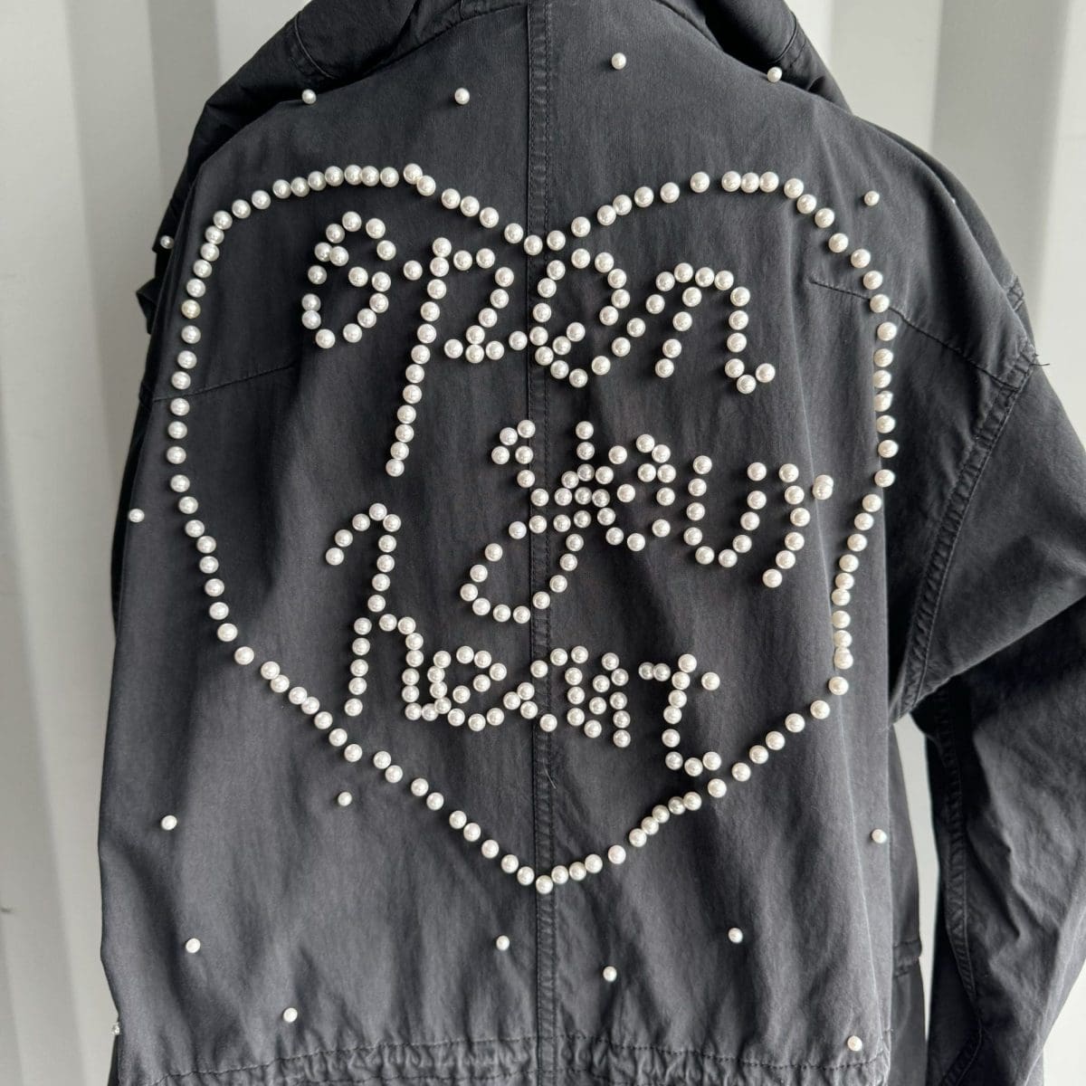 Trench style jacket with pearl beading on back